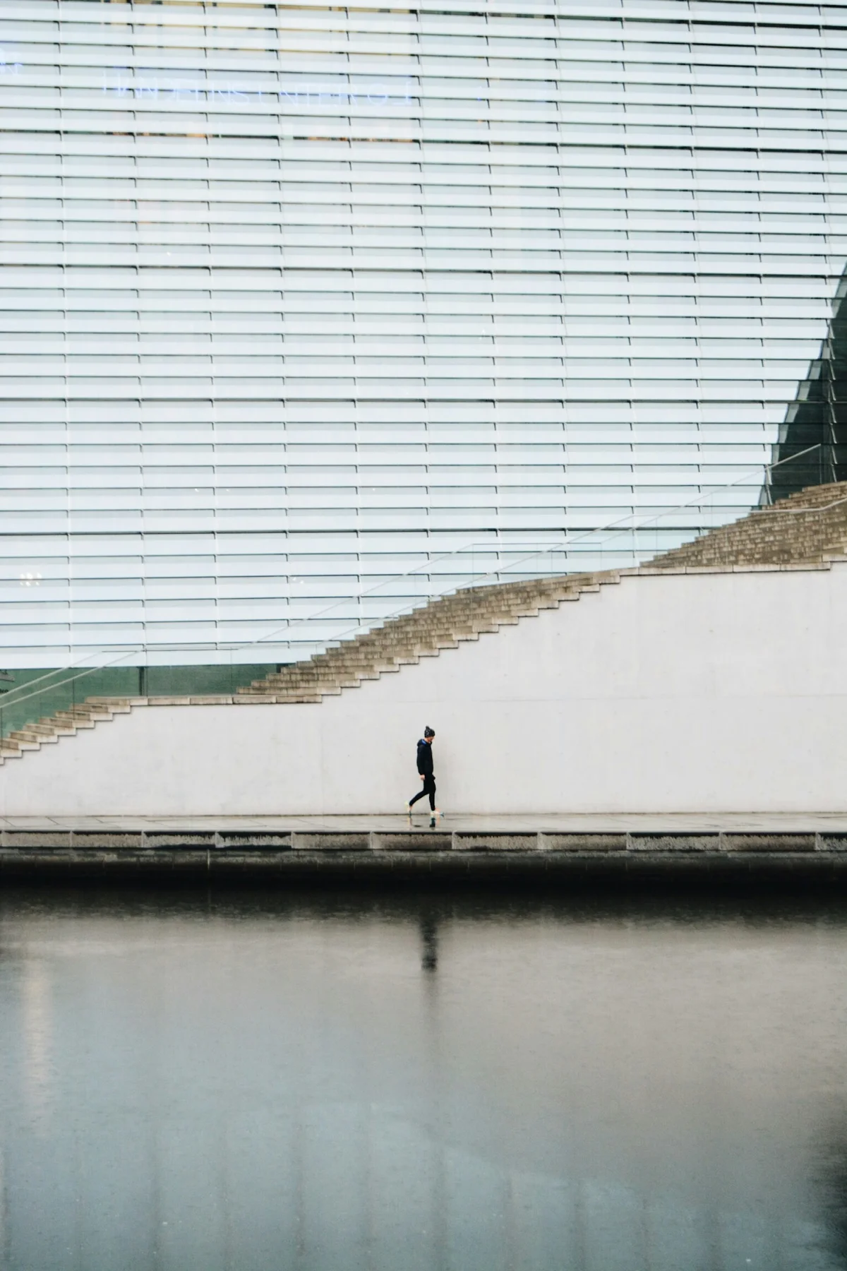 A person moving through a carefully composed architectural space